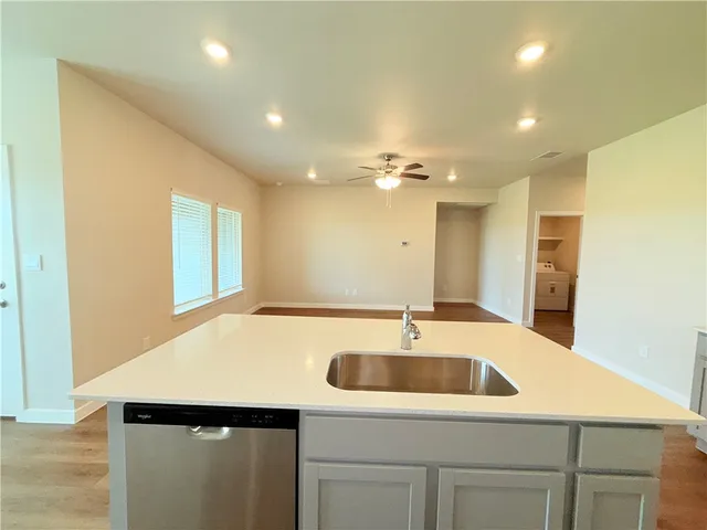 a kitchen with a sink and a refrigerator