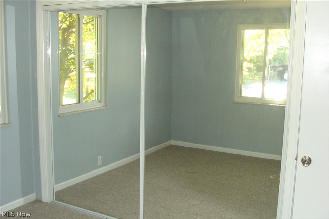 2230 Graham Road Stow, OH 44224 - Photo 18 of 34 Bedroom number 2 on main floor has sliding mirror doors on the closet which makes the room seem larger and all the natural light