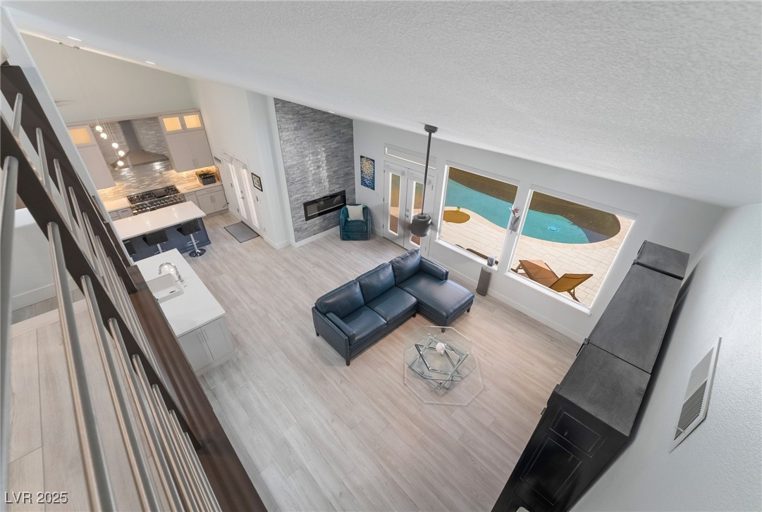 188 Carthage Street Henderson, NV 89074 - Photo 12 of 56 Living room with light wood-style floors, a textur