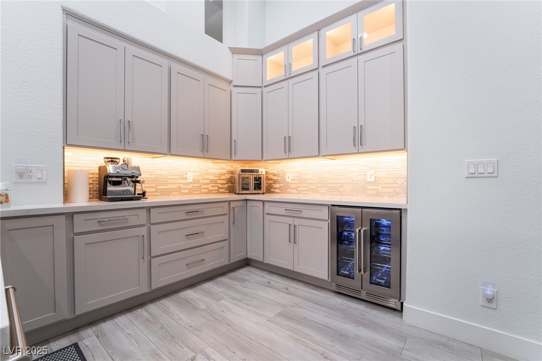 188 Carthage Street Henderson, NV 89074 - Photo 19 of 56 Bar area featuring wine cooler, decorative backspl