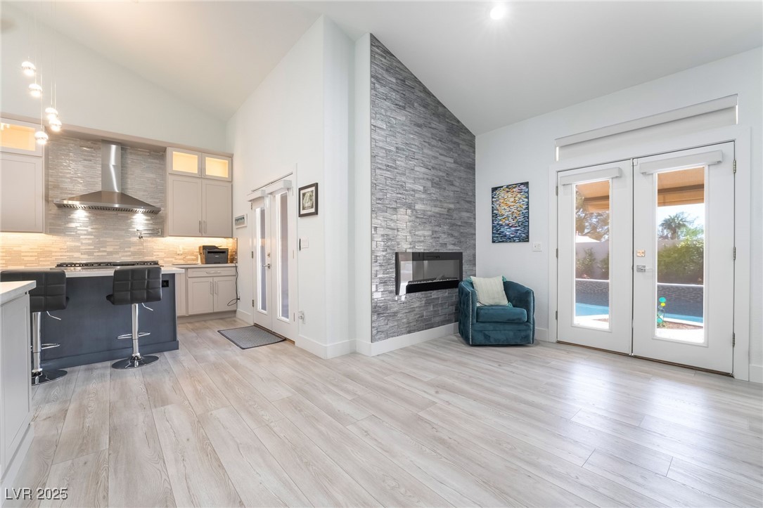 188 Carthage Street Henderson, NV 89074 - Photo 26 of 56 Living area with high vaulted ceiling, a stone fir