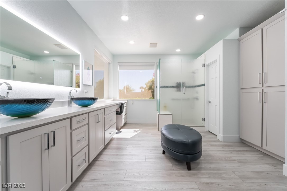 188 Carthage Street Henderson, NV 89074 - Photo 33 of 56 Bathroom with a stall shower, baseboards, wood fin