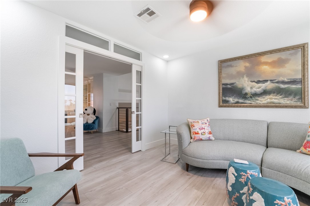 188 Carthage Street Henderson, NV 89074 - Photo 39 of 56 Living area with french doors, light wood-style fl