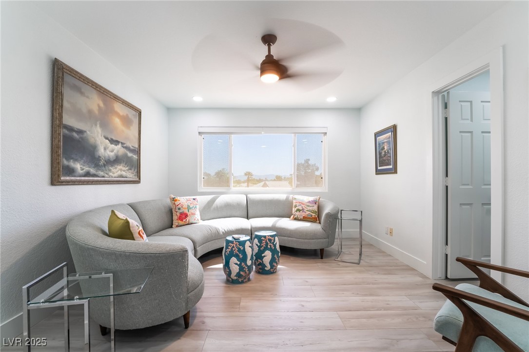 188 Carthage Street Henderson, NV 89074 - Photo 40 of 56 Living room featuring a ceiling fan, light wood-st
