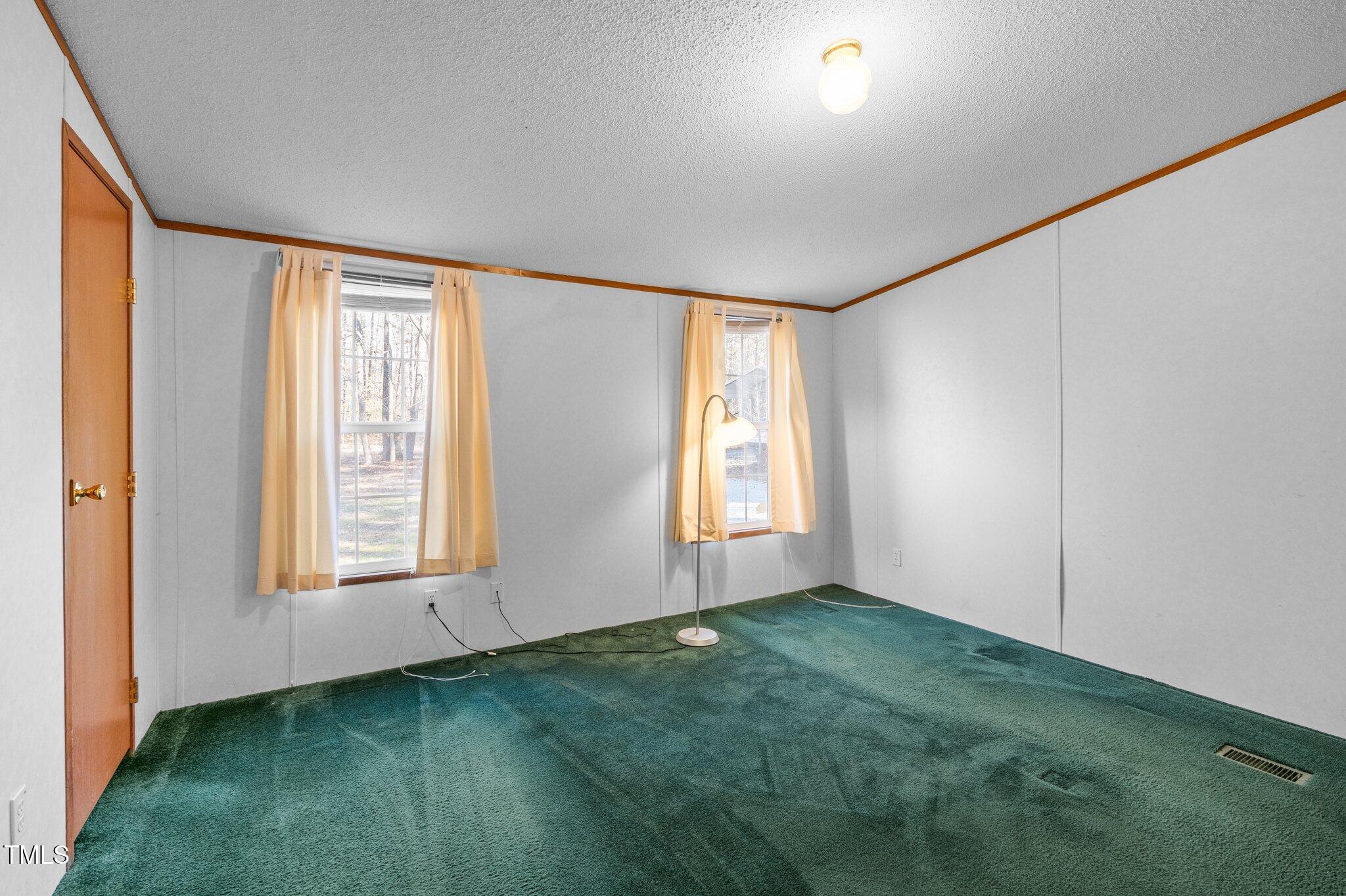 149 Michael Jones Road Roxboro, NC 27574 - Photo 12 of 32 an empty room with window
