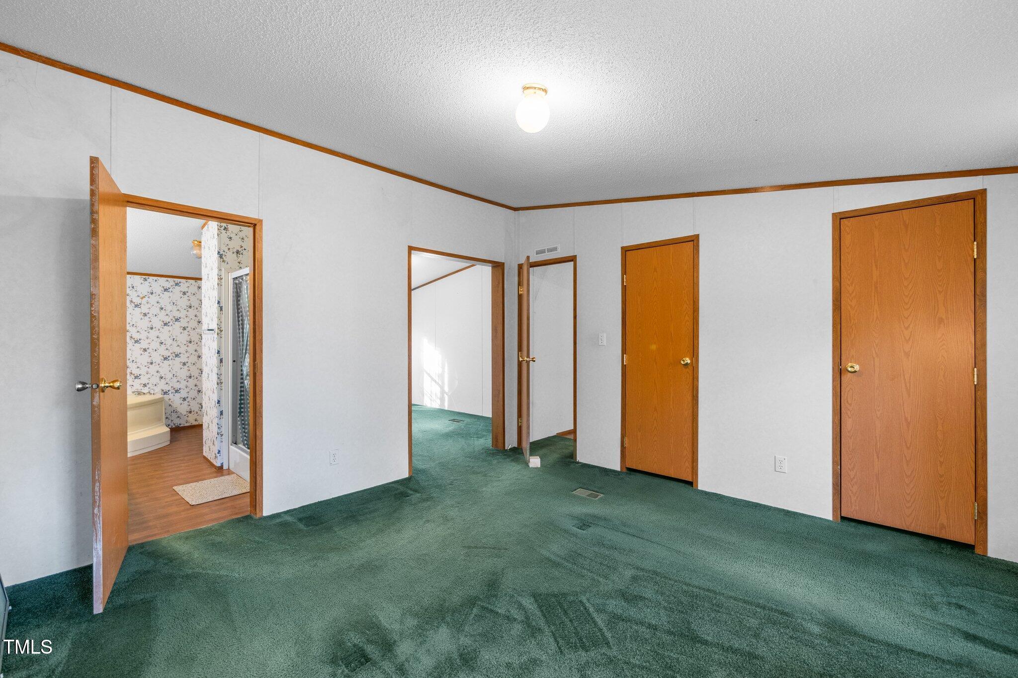 149 Michael Jones Road Roxboro, NC 27574 - Photo 13 of 32 a view of an empty room with closet and a window