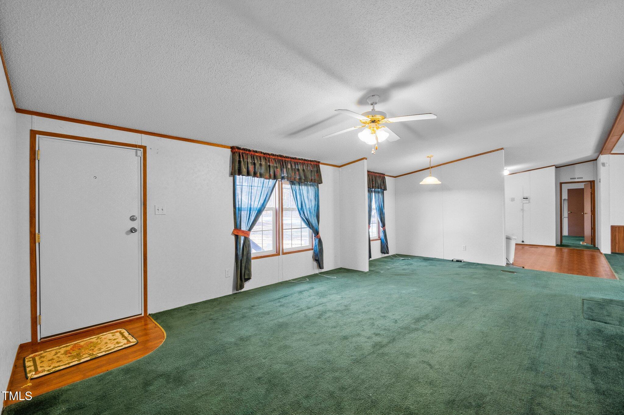 149 Michael Jones Road Roxboro, NC 27574 - Photo 18 of 32 wooden floor in an empty room with a window