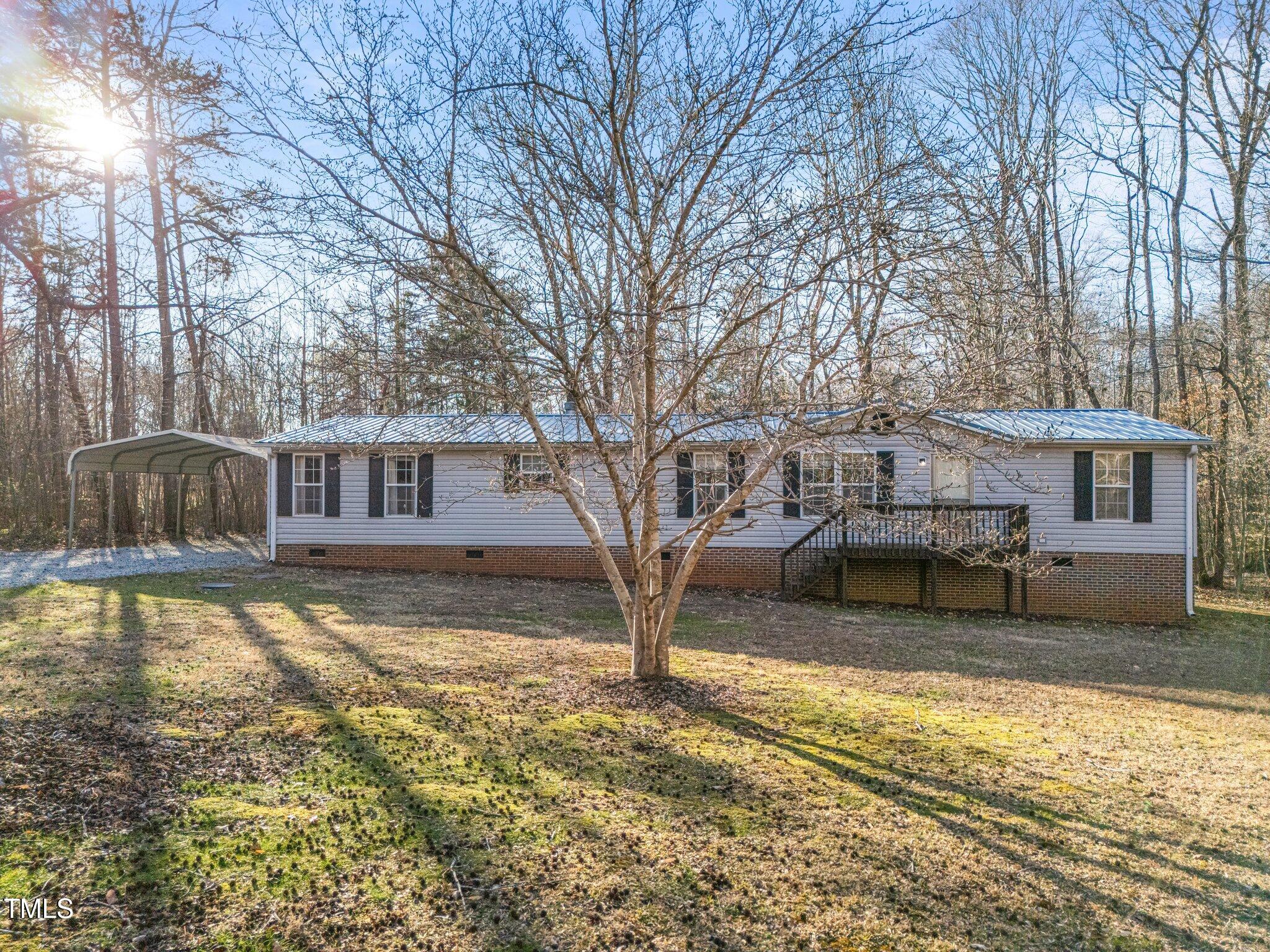149 Michael Jones Road Roxboro, NC 27574 - Photo 2 of 32 a view of a house with a yard covered in snow