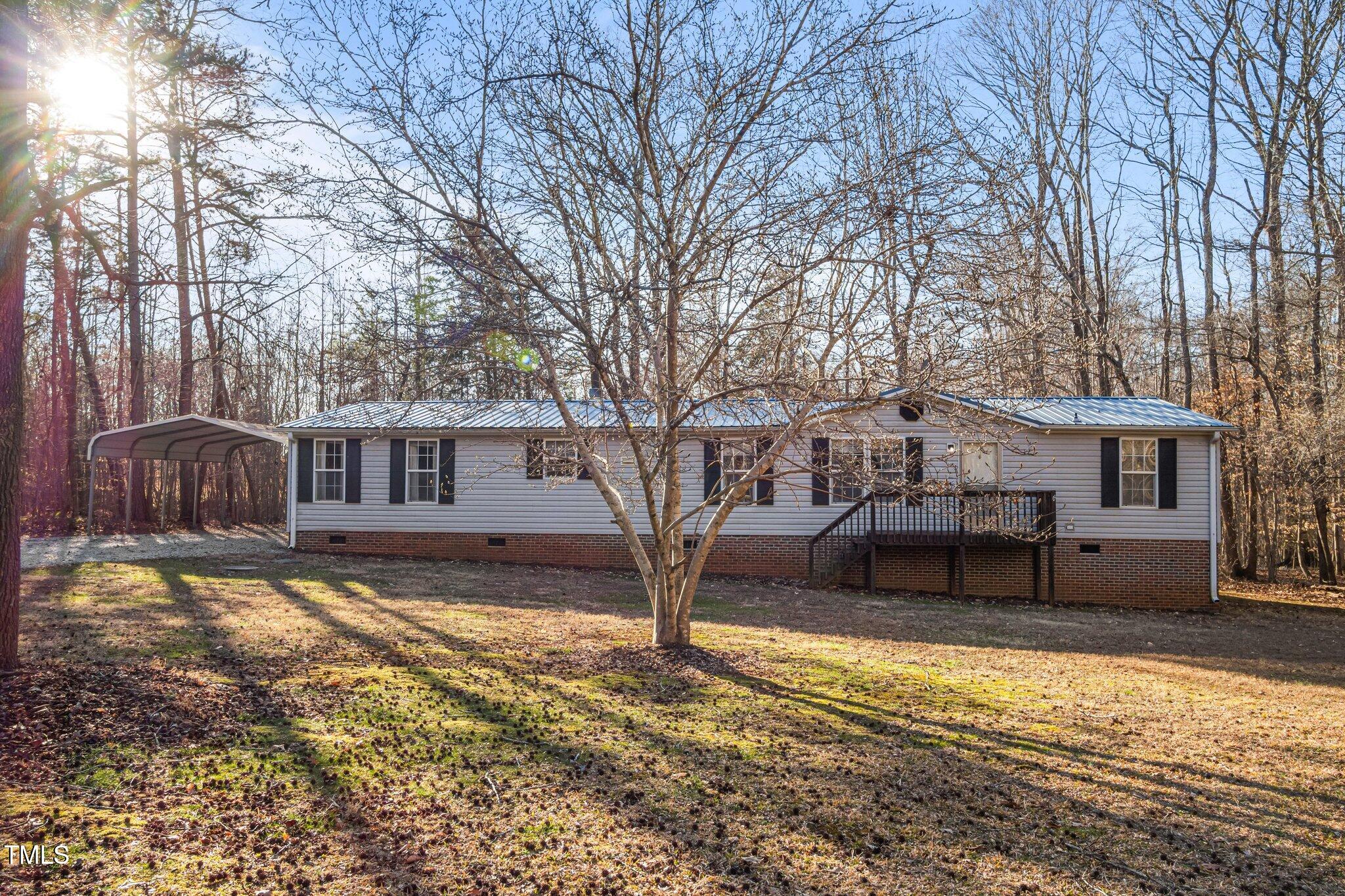 149 Michael Jones Road Roxboro, NC 27574 - Photo 25 of 32 a house that has a tree in front of it