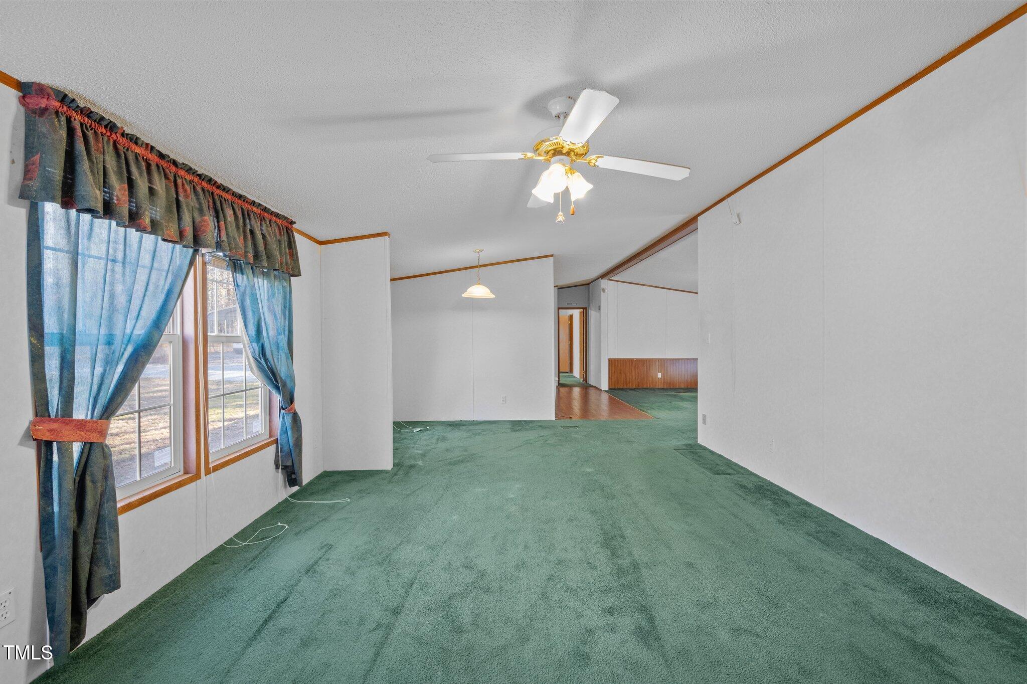149 Michael Jones Road Roxboro, NC 27574 - Photo 4 of 32 a view of an empty room with stairs and a chandelier fan
