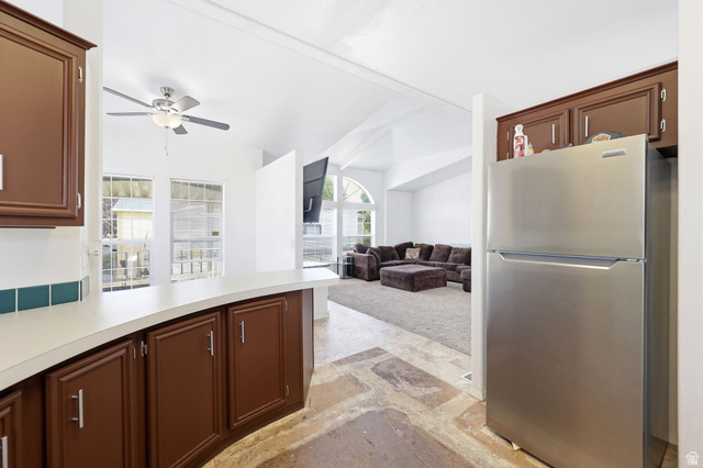 2491 Highway 89, Unit 614 Pleasant View, UT 84404 - Photo 10 of 27 Kitchen featuring wood-finish cabinetry, a built-in stainless steel refrigerator, white countertops, and a green tile backsplash