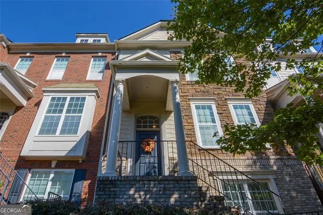 a front view of a residential apartment building with a yard