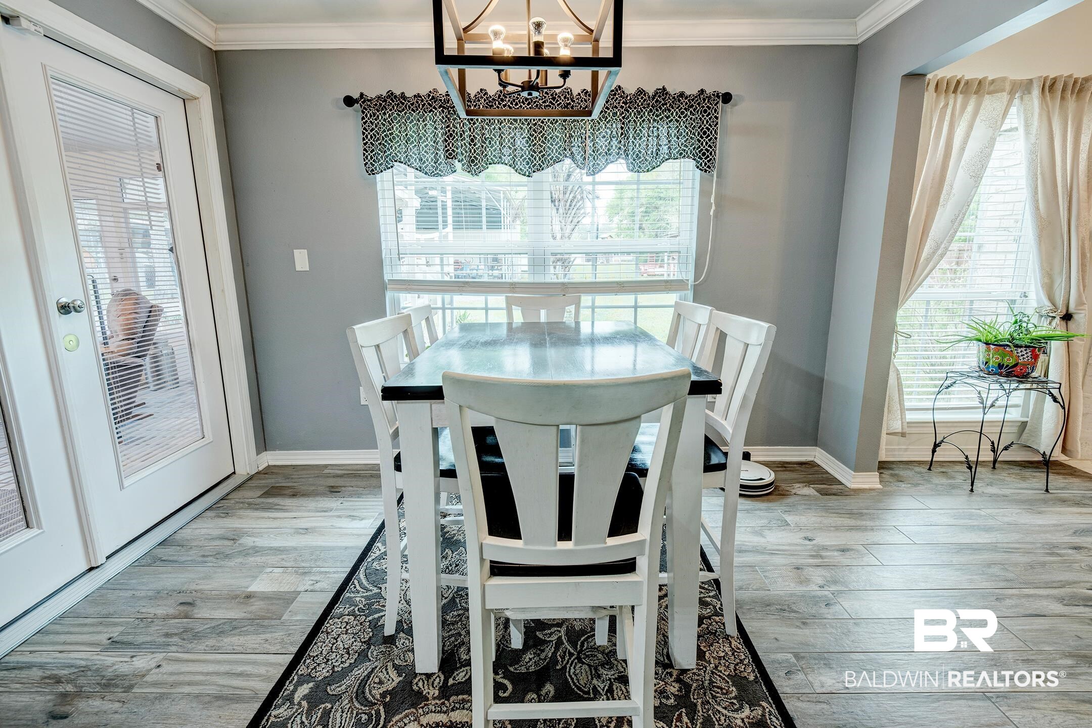 10093 Willis Road Foley, AL 36535 - Photo 21 of 33 Dining area featuring light wood-style flooring, ornamental molding, and hanging lights
