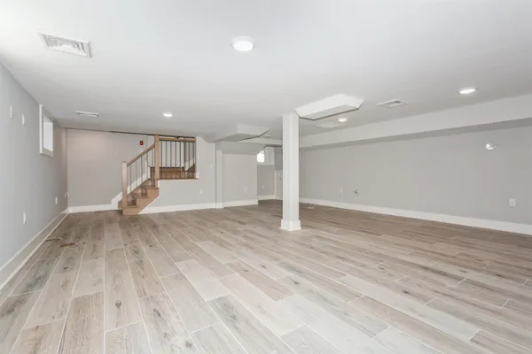 a view of empty room with wooden floor