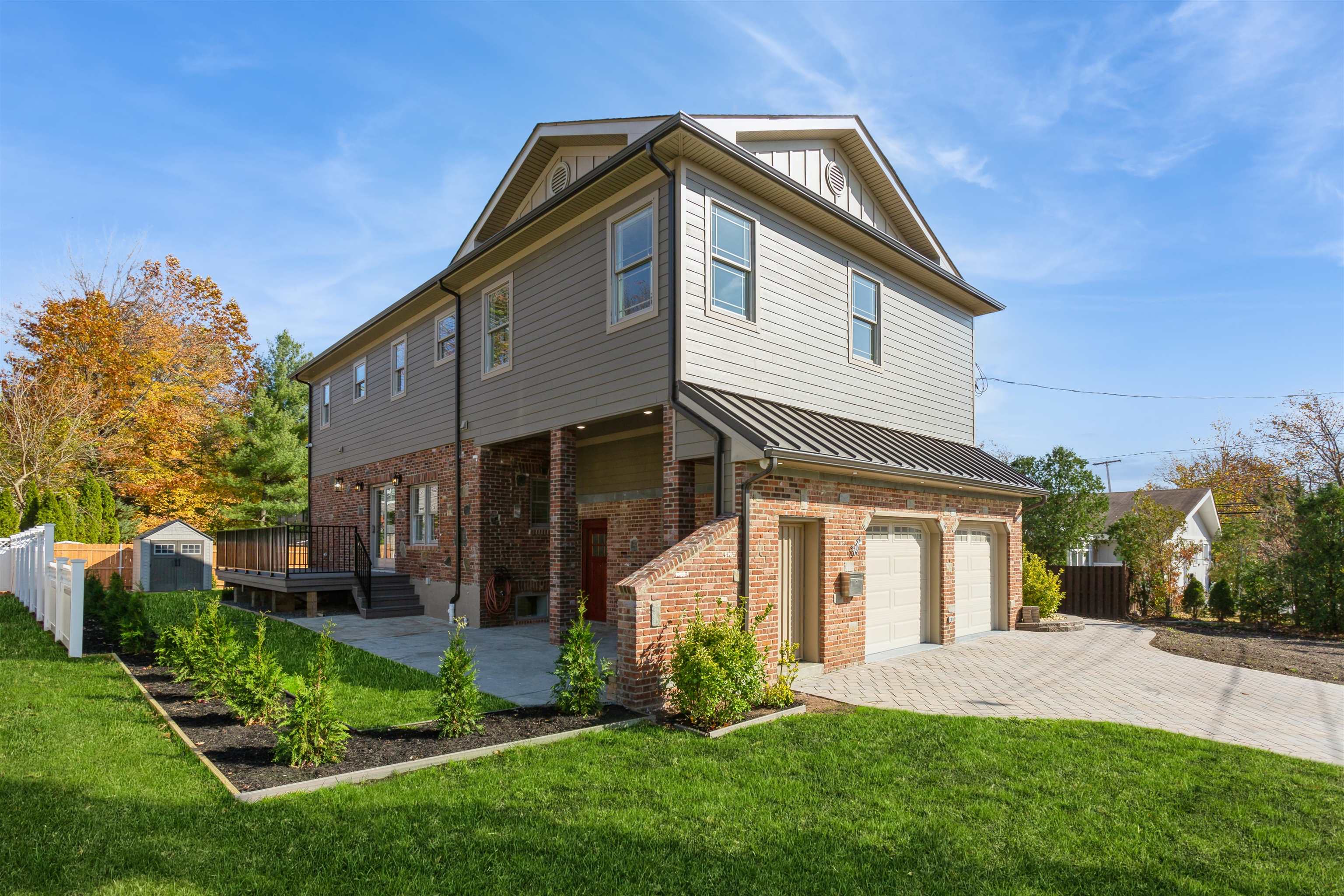 8 Gregory Road Springfield, NJ 07081 - Photo 22 of 30 a front view of a house with a yard and trees