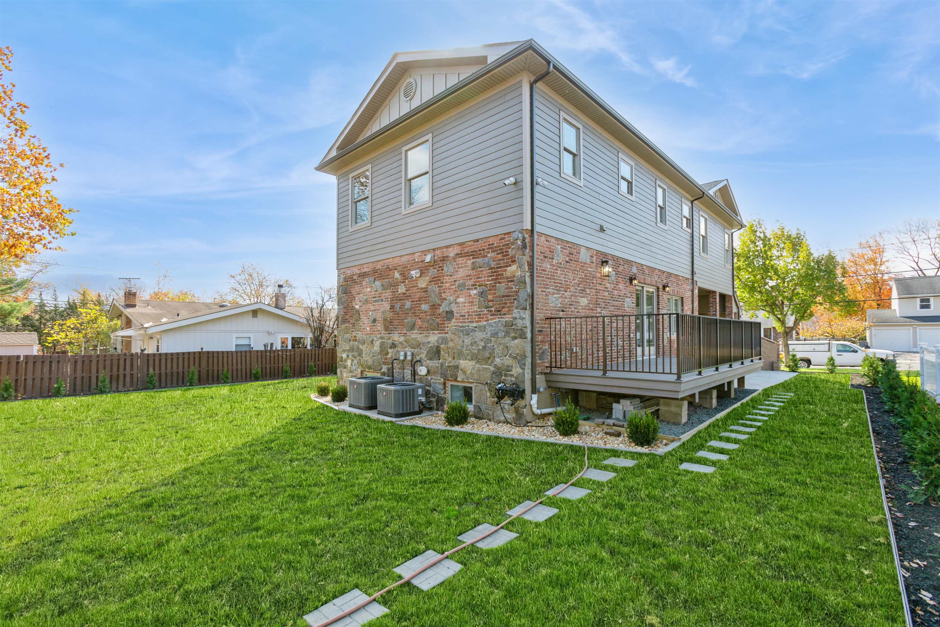 8 Gregory Road Springfield, NJ 07081 - Photo 25 of 30 a backyard of a house with plants and large trees