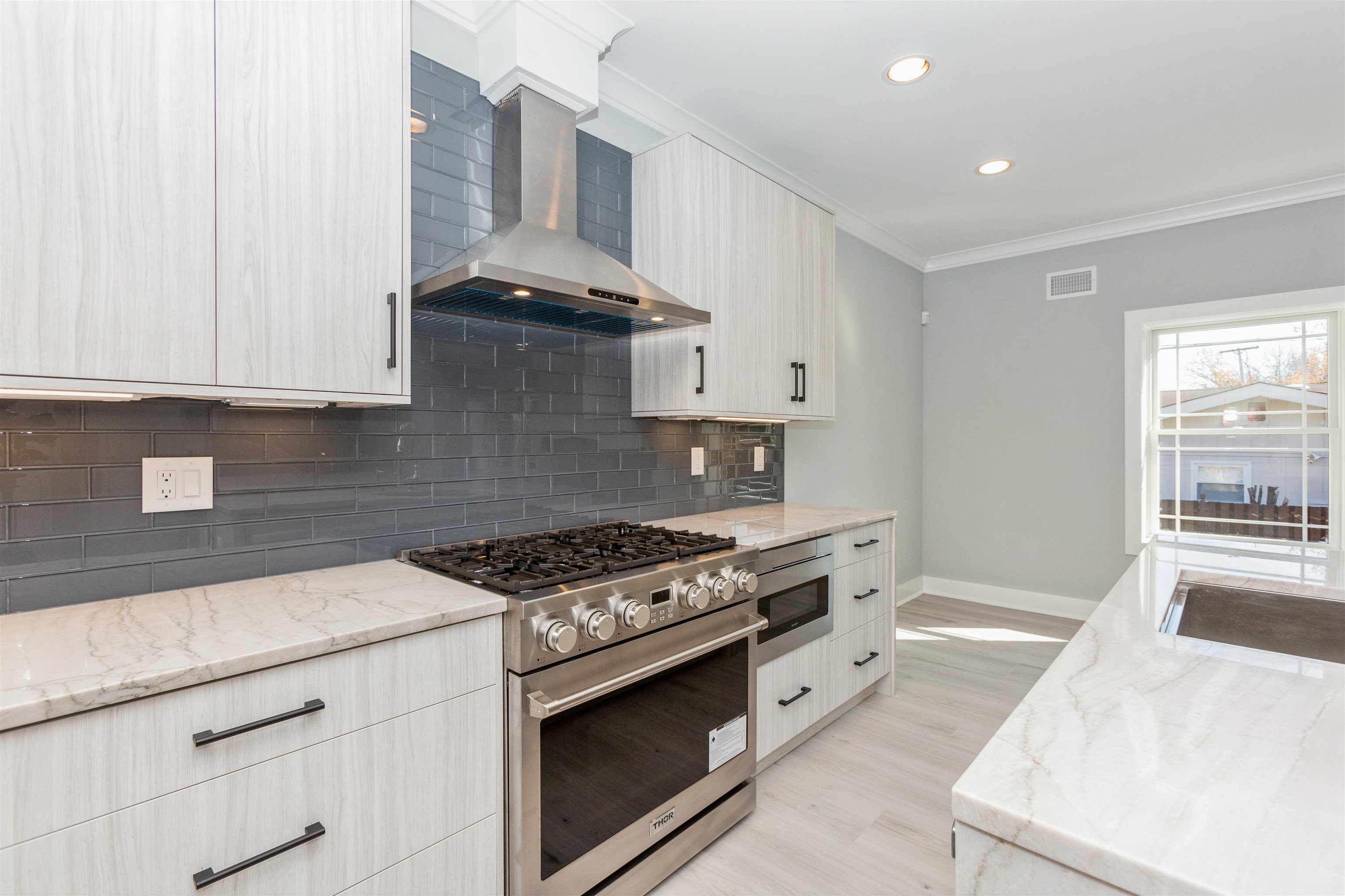 8 Gregory Road Springfield, NJ 07081 - Photo 5 of 30 a kitchen with stainless steel appliances granite countertop a stove and a white cabinets
