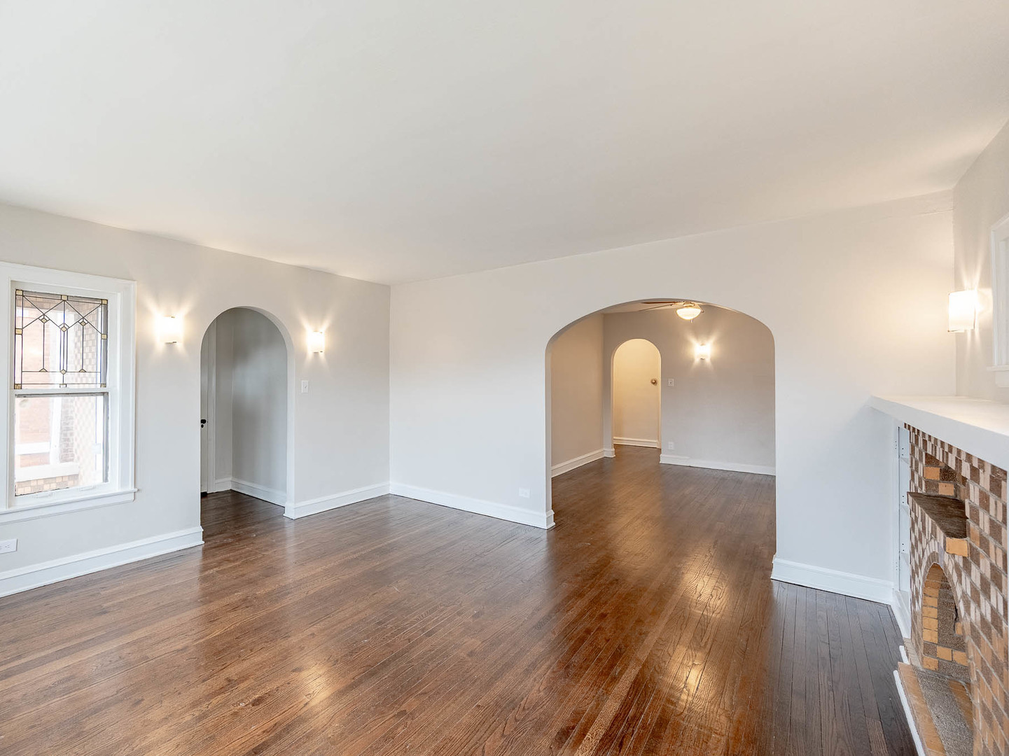 5238 West Wolfram Street Chicago, IL 60641 - Photo 2 of 15 a view of empty room with wooden floor and fan