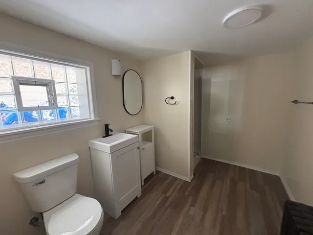 a white toilet sitting next to a bathroom sink