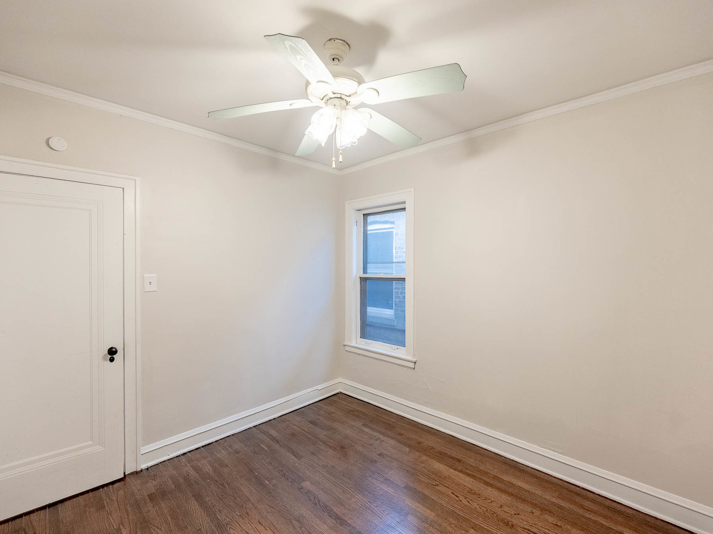 5238 West Wolfram Street Chicago, IL 60641 - Photo 9 of 15 an empty room with wooden floor fan and windows