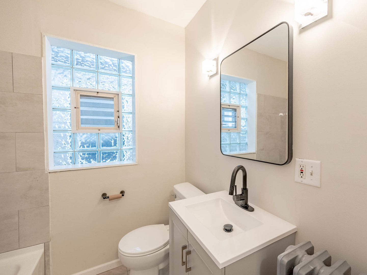 5238 West Wolfram Street Chicago, IL 60641 - Photo 10 of 15 a bathroom with a sink a mirror and a toilet