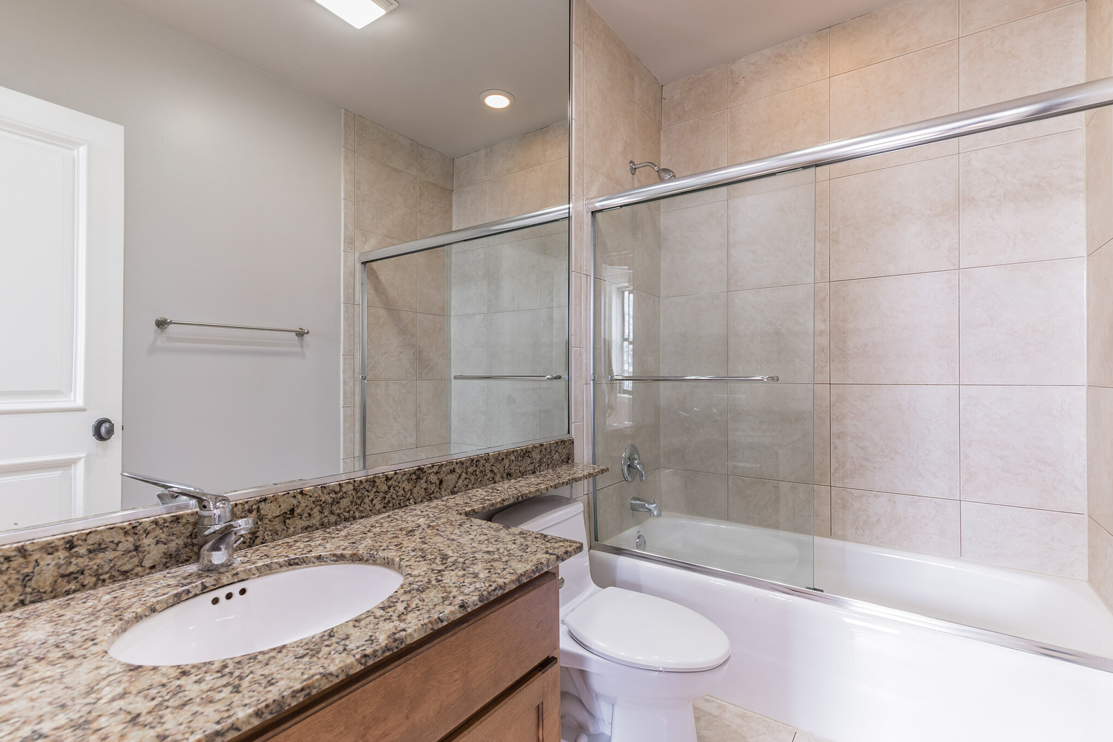 166 West Grand Avenue, Unit 3B Chicago, IL 60654 - Photo 14 of 16 a bathroom with a granite countertop sink toilet and shower