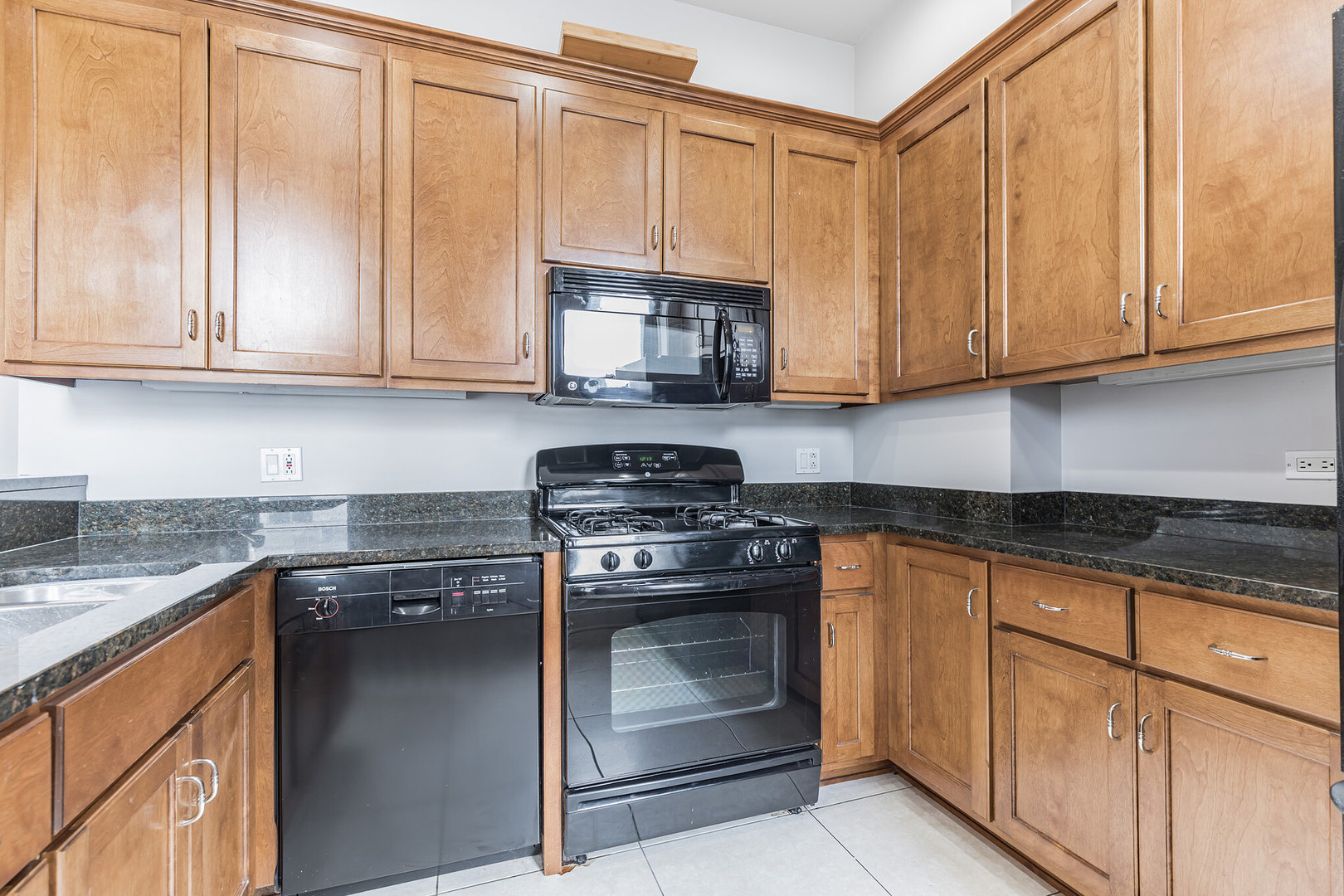 166 West Grand Avenue, Unit 3B Chicago, IL 60654 - Photo 7 of 16 a kitchen with granite countertop cabinets stainless steel appliances and a sink