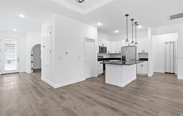 a kitchen with stainless steel appliances a refrigerator sink and cabinets