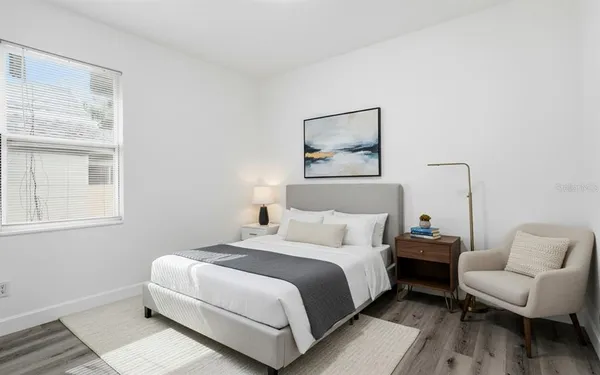 a bedroom with a bed and a couch