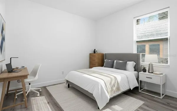 a bedroom with a bed and a table in it