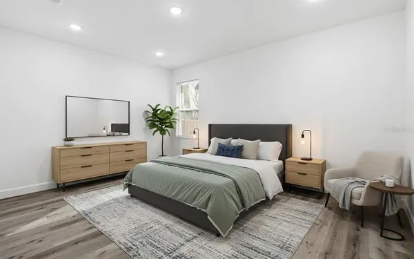 a bedroom with a bed and a couch