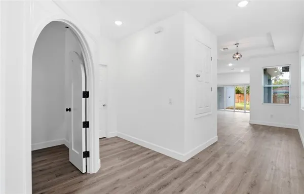 a view of a room with wooden floor