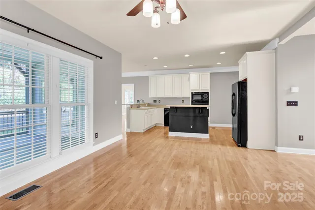 a view of kitchen with stainless steel appliances granite countertop a refrigerator and a sink