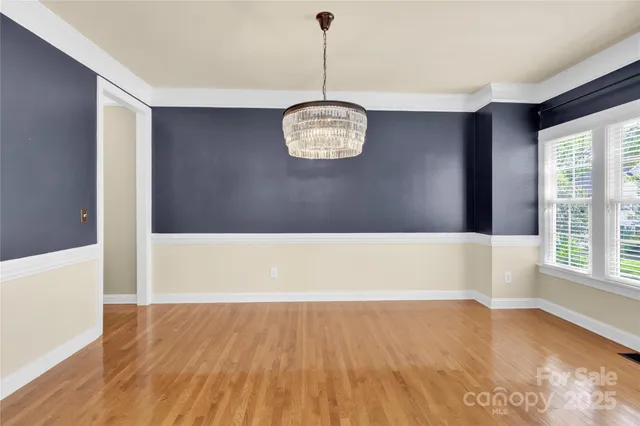 a view of a room with wooden floor and windows
