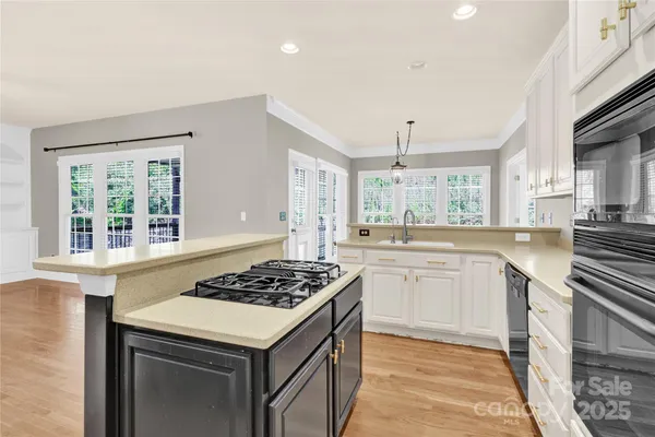 a kitchen with a stove a sink and a refrigerator