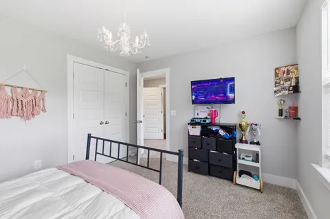 a bedroom with furniture and a chandelier
