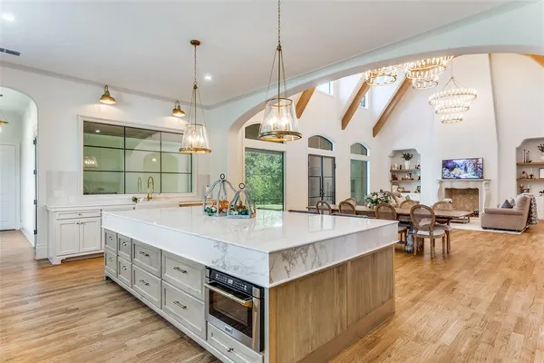 a large white kitchen with a large window