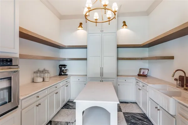a kitchen with sink a stove and cabinets