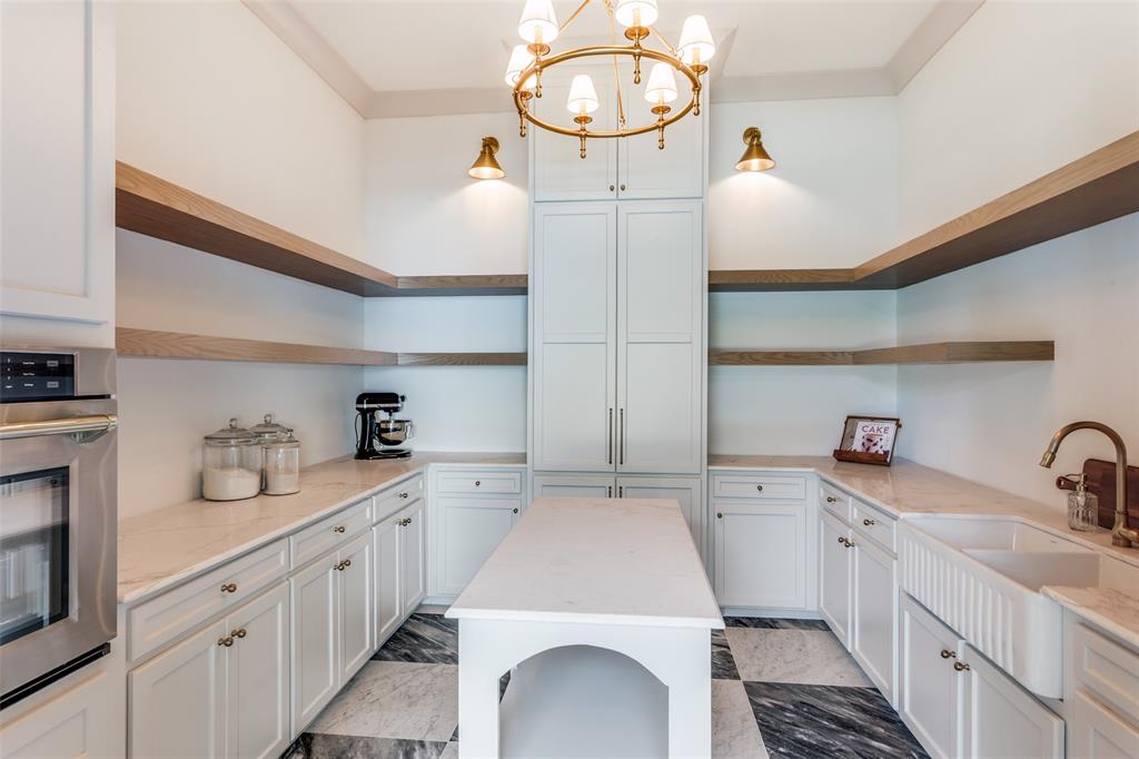 1133 Bourland Road Keller, TX 76248 - Photo 12 of 39 a kitchen with sink a stove and cabinets