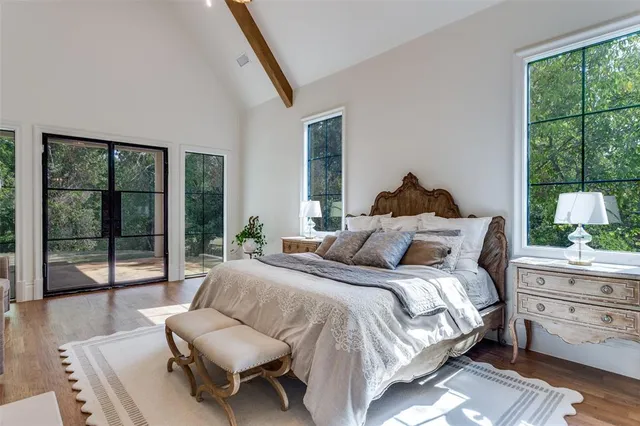 a bedroom with a bed and a large window