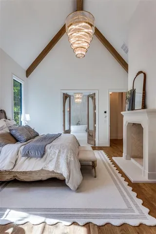 a bedroom with a bed and a large window