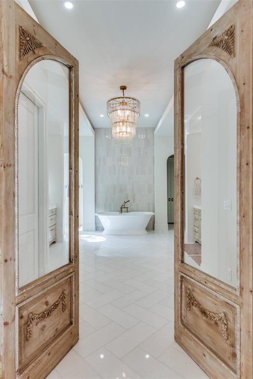 1133 Bourland Road Keller, TX 76248 - Photo 17 of 39 a view of a hallway with windows and chandelier