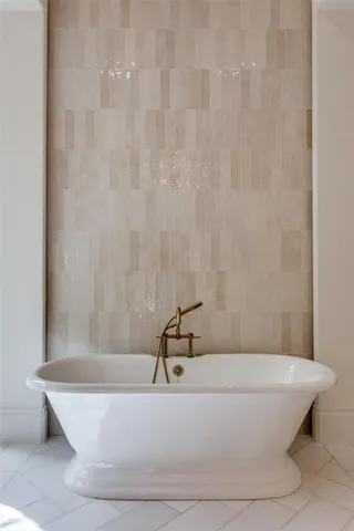 a white tub sitting next to a shower