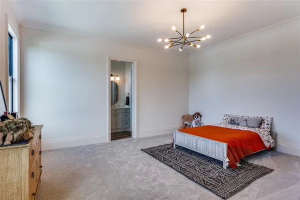 a bedroom with a bed and chandelier