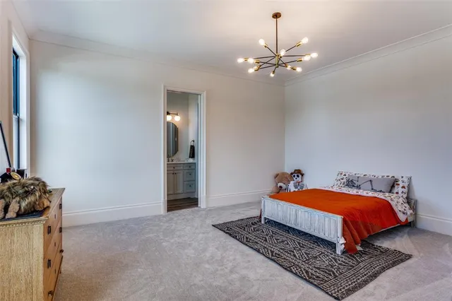 a bedroom with a bed and chandelier