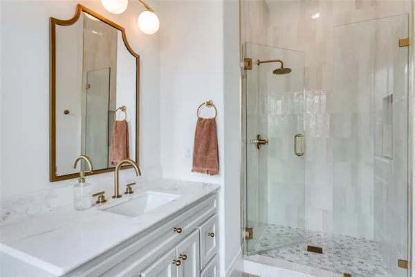 a bathroom with a double vanity sink shower and a mirror