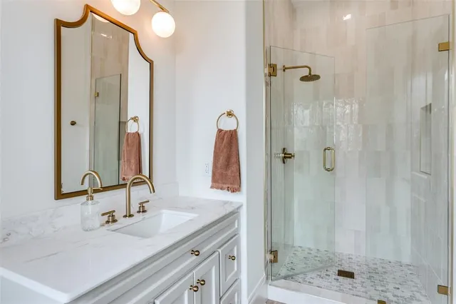 a bathroom with a double vanity sink shower and a mirror