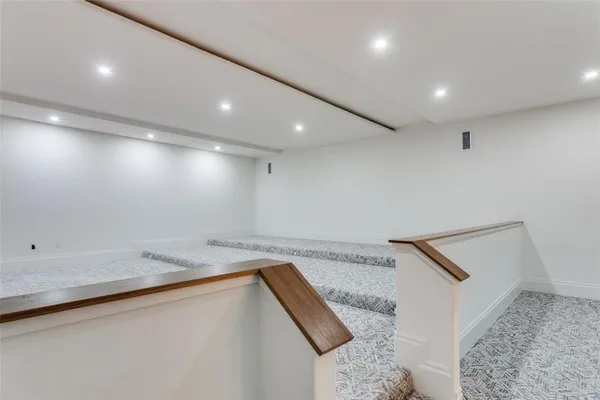 a bathroom with a granite countertop sink and a bathtub
