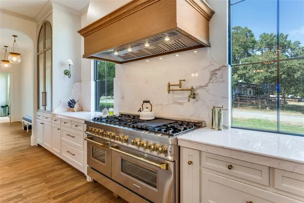a kitchen with stainless steel appliances granite countertop a stove and a sink