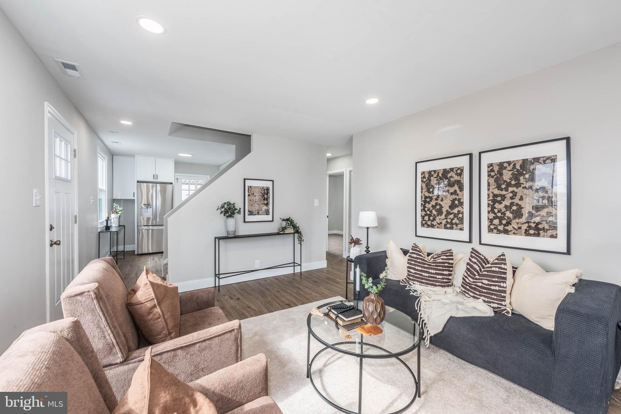 8106 Murray Point Road Dundalk, MD 21222 - Photo 1 of 32 a living room with furniture kitchen view and a wooden floor